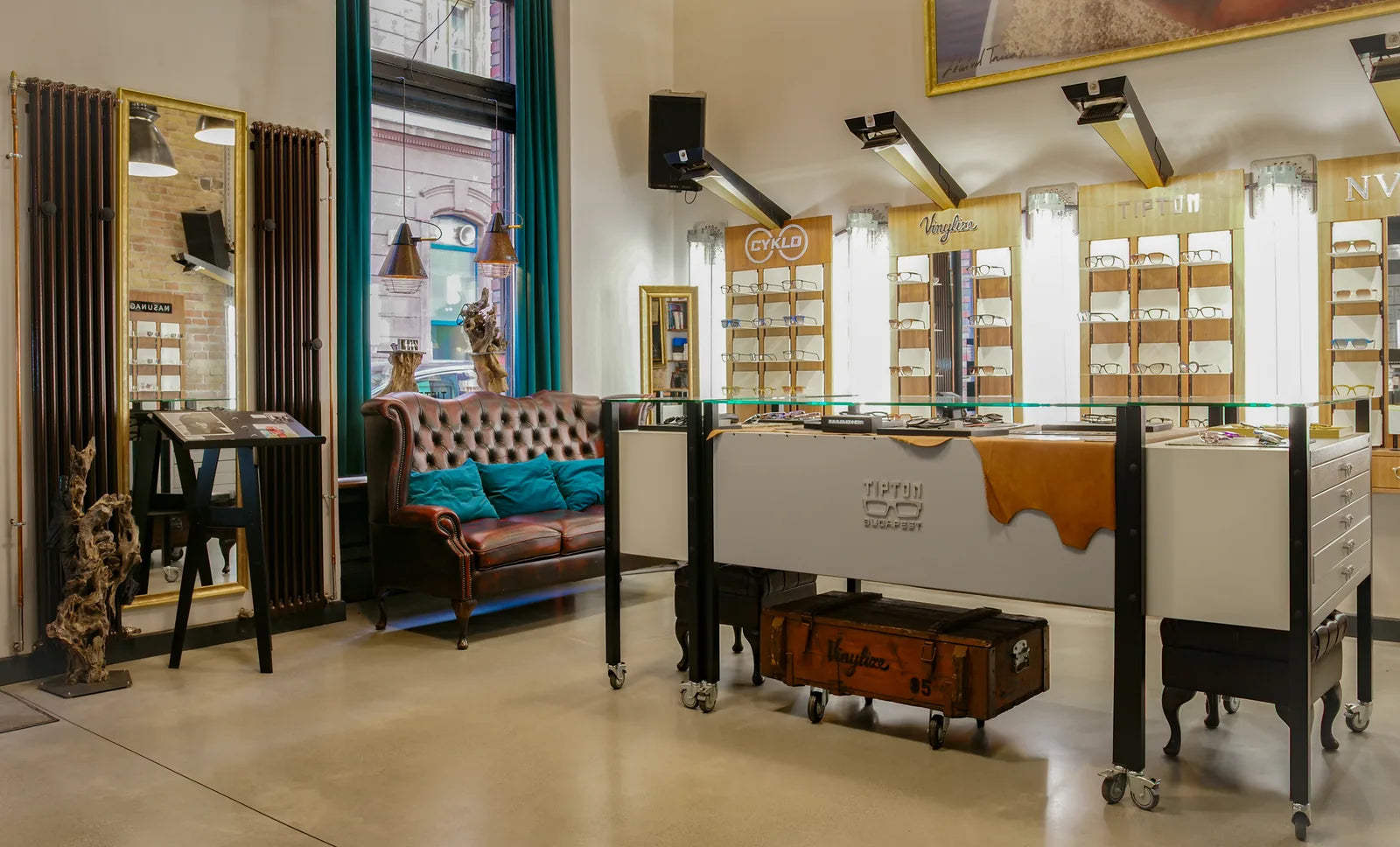Inside the Tipton Eyeworks showroom in Budapest: leather sofa, frame walls and the Tipton counter